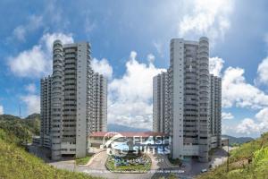two tall apartment buildings on a hill with a sky at Amber Court Premium Suites @ Genting Highlands in Genting Highlands
