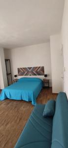 a bedroom with two beds and a couch in it at Suite Centrale 44 OCEANO in Marsala