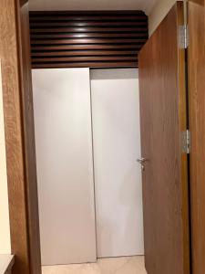 a closet with white doors in a room at Santa Marina Apartment 503 in Sozopol