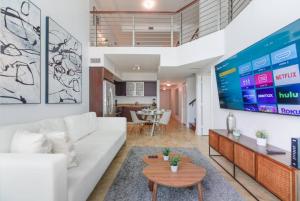 a living room with a white couch and a table at Fantastic Open Loft Design Double Height in Miami