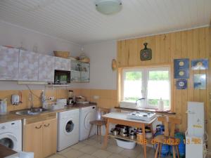 a kitchen with a sink and a washing machine at Gdzie diabeł mówi dobranoc in Pisz