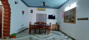 a dining room with a table and chairs at Jinan palace guest house Jinan palace guest house in Nedumbassery
