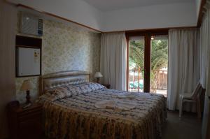a bedroom with a bed with towels on it at Complejo Turístico CapArcona in Villa Gesell +27 photos