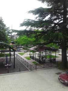 a park with benches and trees and a playground at Black Sea in K'obulet'i