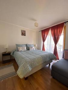 a bedroom with a bed and a large window at Cabaña Vientos del Puclaro in Vicuña +9 photos