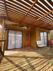 a porch of a house with a wooden deck at Cabaña Vientos del Puclaro in Vicuña