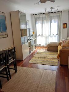 ヒホンにあるIradri, Apartamento Playa Gijónのリビングルーム(ベッド1台、ソファ付)