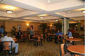 a group of people sitting at tables in a restaurant at Hampton Inn Laplace in Laplace