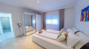 a living room with a couch and a bedroom at Villa Carpe Diem - with private pool in Mostar +60 photos