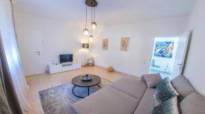 a living room with a couch and a table at Villa Carpe Diem - with private pool in Mostar