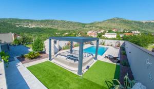 an overhead view of a backyard with a pool and grass at Villa Carpe Diem - with private pool in Mostar