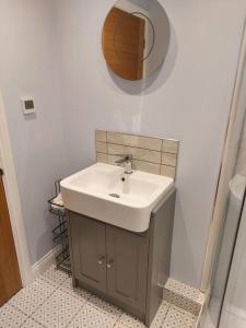 a bathroom with a sink and a mirror on the wall at Detached 2 bedroomed bungalow Billingham Stockton on Tees in Stockton-on-Tees