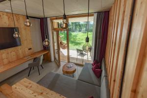 a living room of a tiny house with a couch at Hotel Lärchenhof in Ramsau am Dachstein