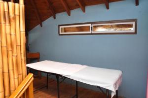 a hospital bed in a room with two windows at Complejo Turístico CapArcona in Villa Gesell