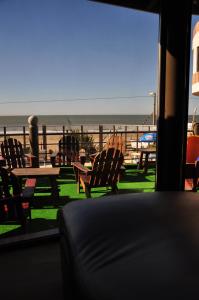 a view of a table and chairs on the beach at Complejo Turístico CapArcona in Villa Gesell