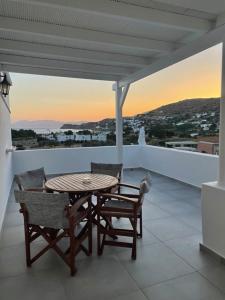 a table and chairs on a balcony with a view at Villa Anna Maria in Mylopotas