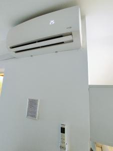 a white air conditioner hanging from a ceiling at A1 - Airport Belgrade Apartment in Belgrade