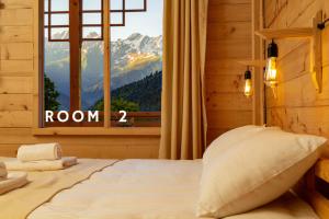a bedroom with a bed with a view of a mountain at Chiora Inn in Chiora