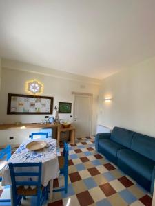 a living room with a blue couch and a table at Palazzo Vecchio Cocumola in Cocumola
