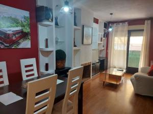 a living room with a table and a dining room at La cabaña in Las Navas del Marqués