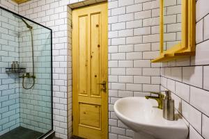 a bathroom with a sink and a yellow door at Chiora Inn in Chiora