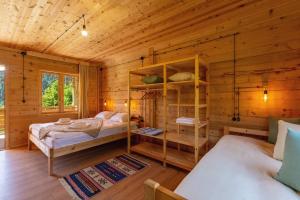 a bedroom with two beds in a wooden cabin at Chiora Inn in Chiora