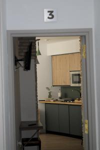 an open door into a kitchen with a counter top at La Cúpula in Córdoba