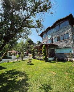 a house with a grass yard in front of it at Kartepe Köşkü in Kartepe