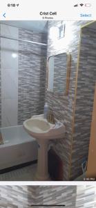 a bathroom with a sink and a tub and a mirror at Luxury Villa rentals in Montego Bay