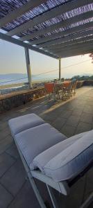 a bed on a patio with a table and chairs at Holiday Home in Sfendouri, Aegina in Sfendoúrion