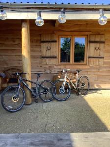 two bikes parked outside of a log cabin at Oak ridge cabin in Norwich