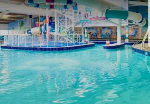 a large swimming pool with a water slide at The Summers residence in Selsey