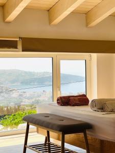a room with a bed and a large window at Tzavelitiko Home in Himare