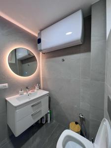 a bathroom with a white sink and a mirror at Vila Seknič in Utjeha