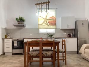 a kitchen with a table and chairs in a room at Landro House in Kissamos