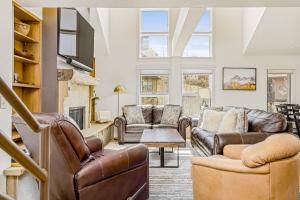 a living room with leather furniture and a fireplace at Blue Mesa 6 - Snow Down in Telluride