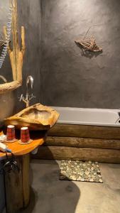 a bathroom with a wooden sink and a bath tub at Green Ecolodge in La Colmiane