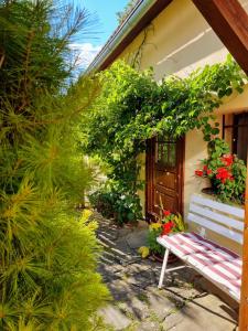 a bench sitting in front of a house with plants at Historical house in the center Levoča with parking in Levoča
