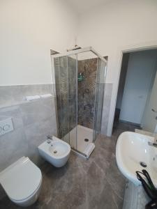 a bathroom with a shower and a toilet and a sink at Adelina House in La Spezia