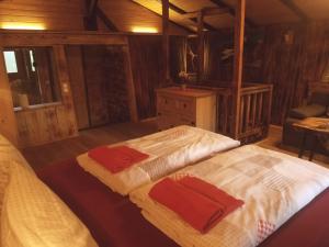 a bedroom with two beds with towels on them at Fronwieshof in Ramsau