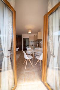 a dining room and kitchen with a table and chairs at Apartments Franovic in Perast