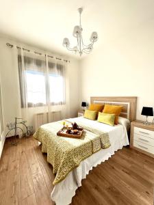a bedroom with a large bed with a tray on it at Descanso Natural Bueu in Bueu +34 photos