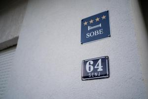 a sign on the side of a building that says at Rooms & Apartment Milan Saborsko in Saborsko