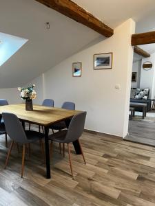 a dining room with a wooden table and chairs at Apartment CENTRO in Kastav