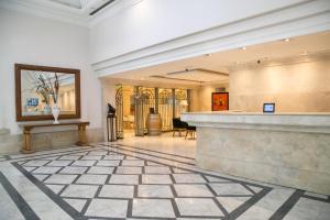 a lobby with a counter in a building at Millennium Inn Mendoza in Mendoza