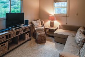 a living room with a flat screen tv and a couch at Woodcrest Pool Paradise in New Buffalo