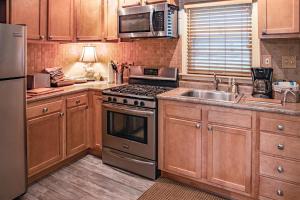 a kitchen with a stove and a sink and a refrigerator at Woodcrest Pool Paradise in New Buffalo