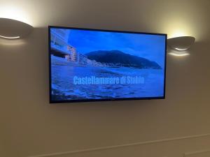 a flat screen tv hanging on a wall at St. Vincent Apartment in Castellammare di Stabia