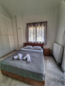 a bedroom with a bed with towels on it at Villa NiaMare in Iraklitsa