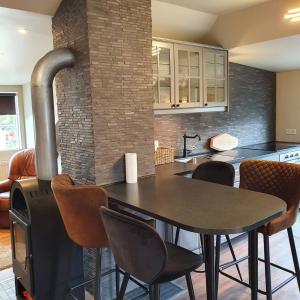 a kitchen with a table and chairs and a stove at E18 Apartments in Akureyri
